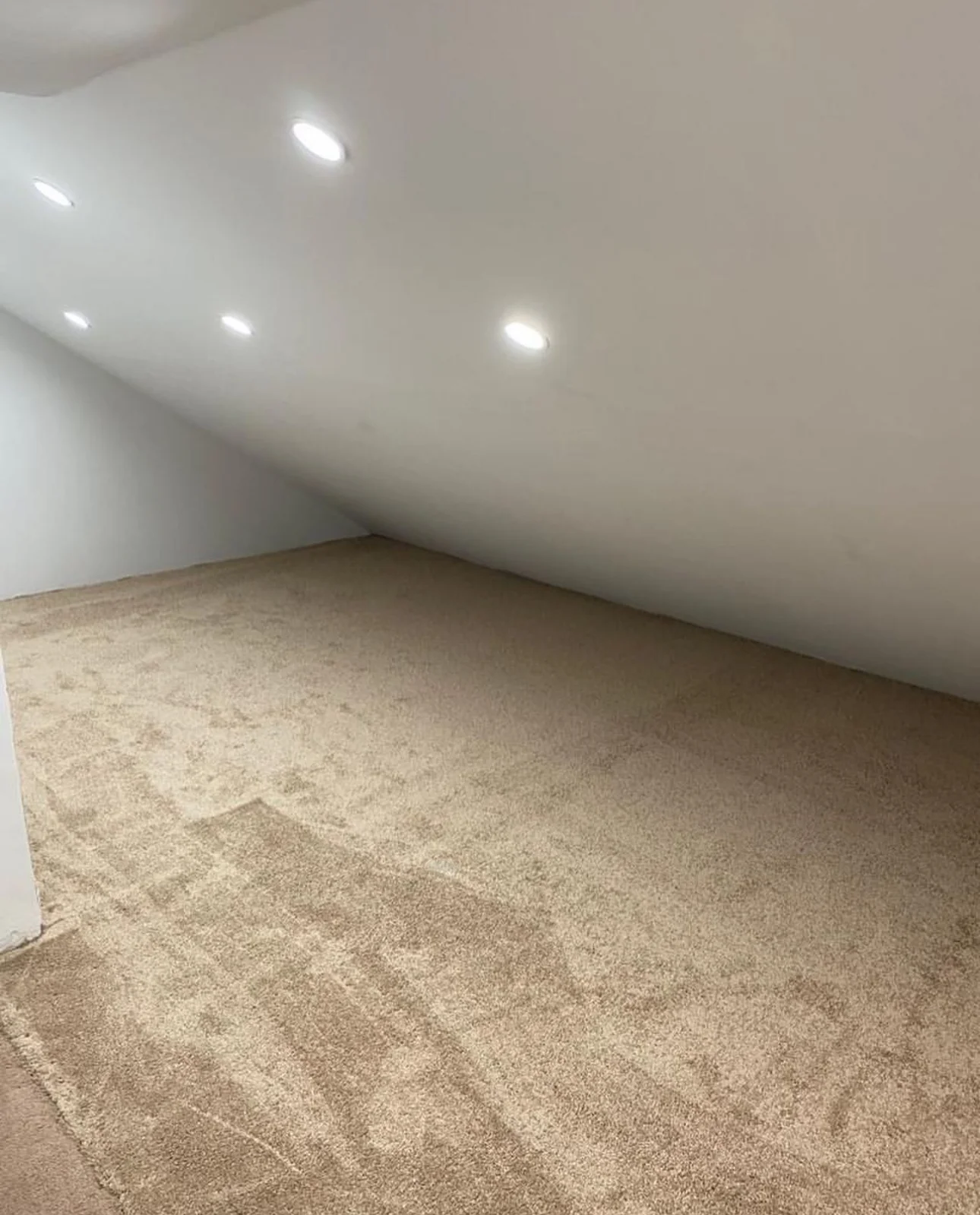 Freshly painted attic room with smooth white ceiling