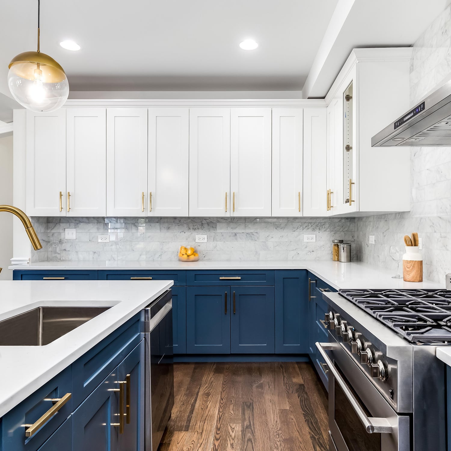 Modern kitchen with white and navy cabinets and marble backsplash