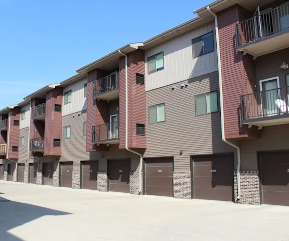 Multi-family residential exterior with fresh siding and garages